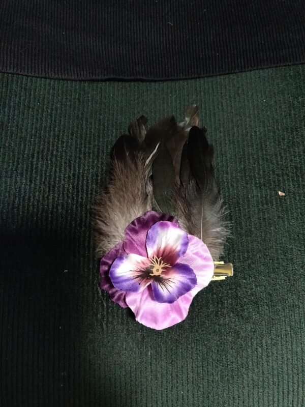 pink/purple pansy with black feathers