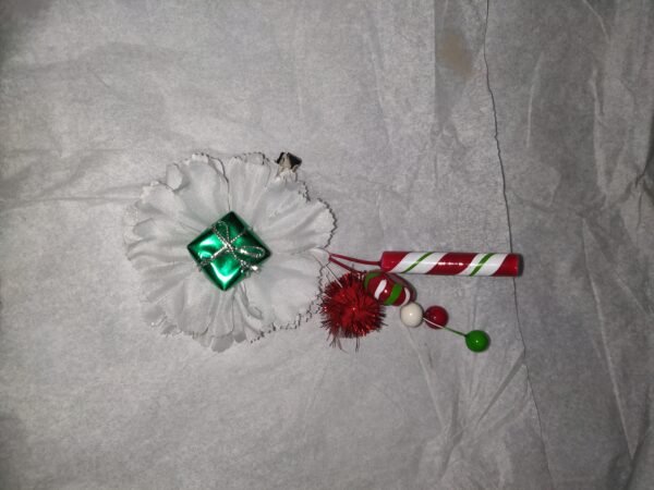 green present on a white carnation with stick candy pick